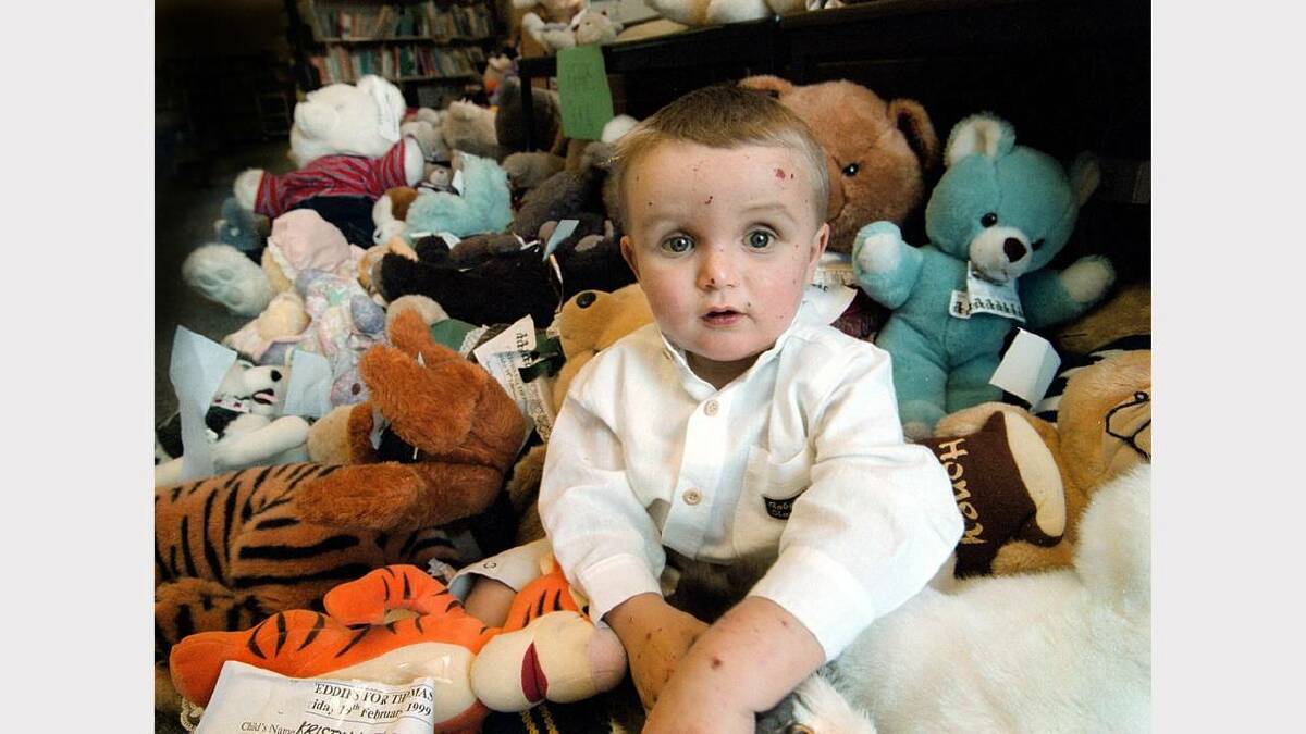Wodonga South Primary School  -  Thomas Whyte, 2, who is waiting for a liver transplant, in amongst some teddy bears at a fundraiser the school had for him. Picture: PETER BATSON