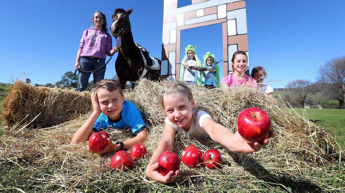 Thomas Moeliker, 9, and Stella Moeliker, 7, hold apples for a fun day game, in front of Hannah Williams, 15, Charlotte Mitchell, 10, Will Mitchell, 8, Ella Mitchell, 12, and Evie Moeliker, 4. Picture: JOHN RUSSELL
