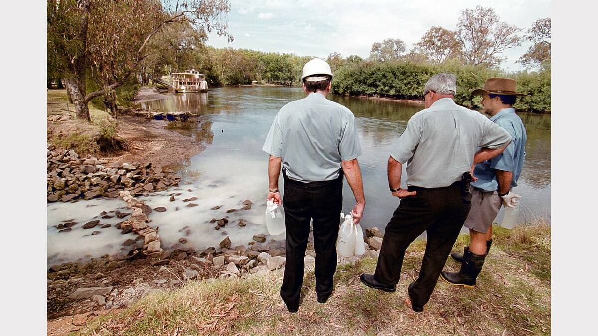 E.P.A acting general Manager David Cook (l)  Barry Gerrard (council ordnance officer) Mark Gerrard (E.P.A. officer) look over a milk spill in the Murray River near Noreuil Park that came from the Paul's Milk Albury depot. Picture: RAY HUNT