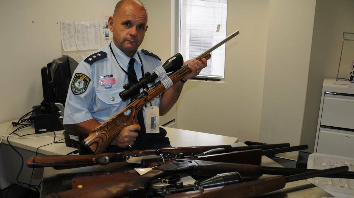 Vigilance: Inspector Dan Skelly from Orana Local Area Command with some of the firearms that have been stolen from rural properties. Photo: BEN WALKER
