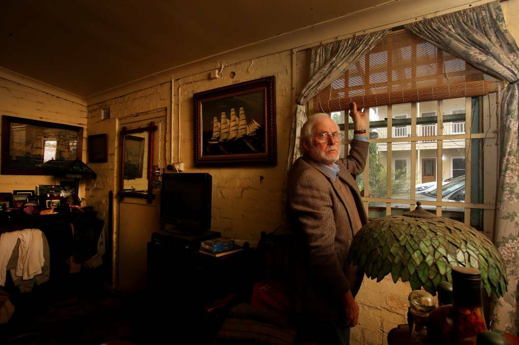 Stuck living in a single room in his Thirroul business, senior citizen Wesley Crittle can't move into his new house behind it because his has to pay $15,000 to get a gas meter installed. Picture: Robert Peet
