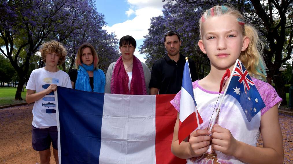 Sarah Arragon (front), Anthony and Aline Arragon, Patricia Strahorn and Daniel Arragon show their sadness and solidarity for the people in their French homeland after the deadly Paris terrorist attacks. Photo: KATHRYN O'SULLIVAN