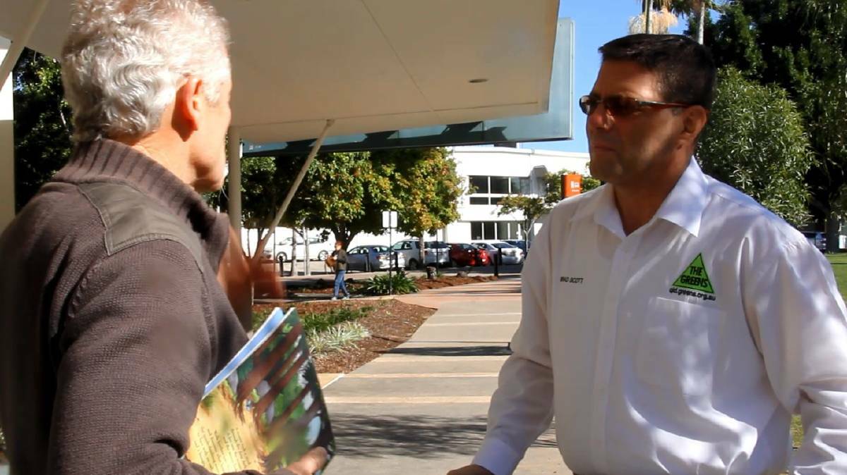 Greens candidate Brad Scott speaks with a voter at Capalaba.
