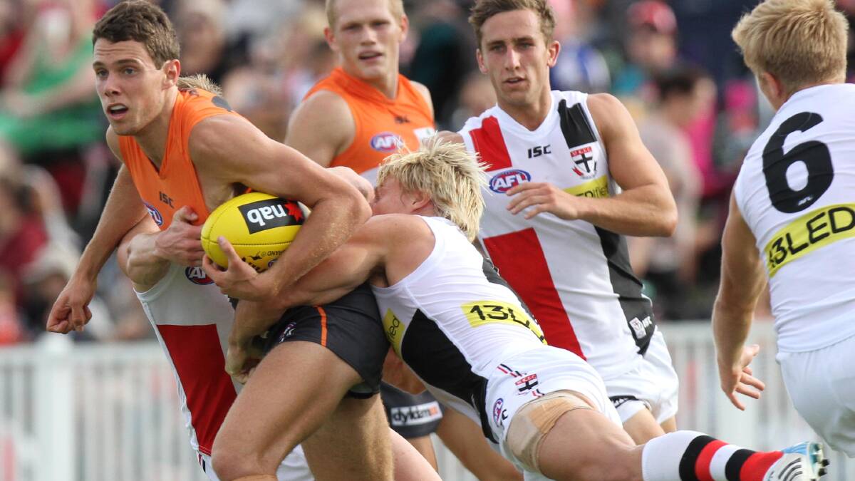 AFL: Giants' Joshua Kelly is tackled by St Kilda's Clint Jones. Picture: Les Smith