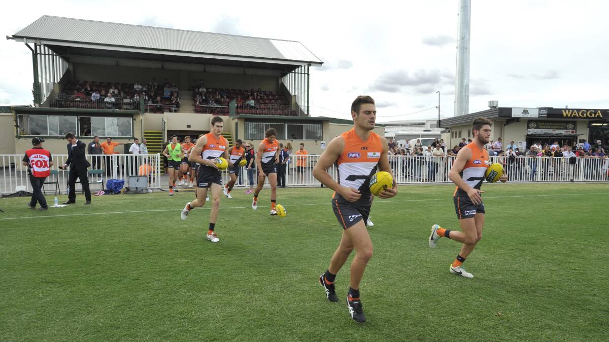 AFL: GWS Giants run onto the field at Robertson Oval. Picture: Les Smith