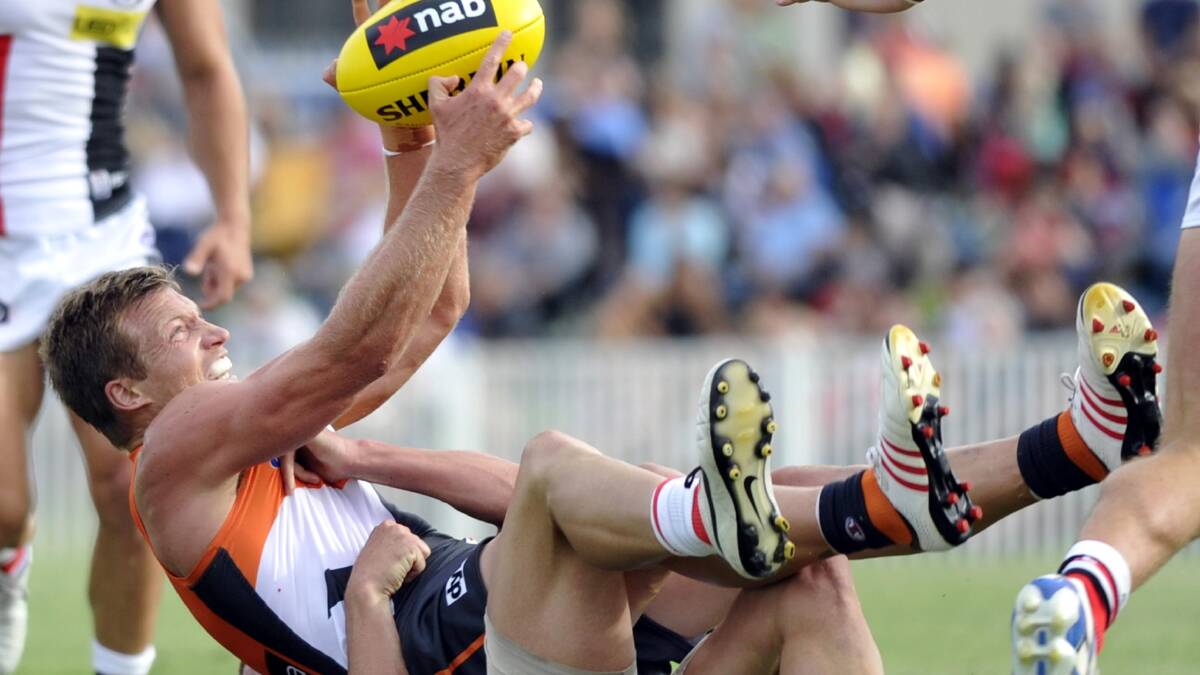 AFL: Giants' Adam Kennedy is tackled to the ground. Picture: Les Smith