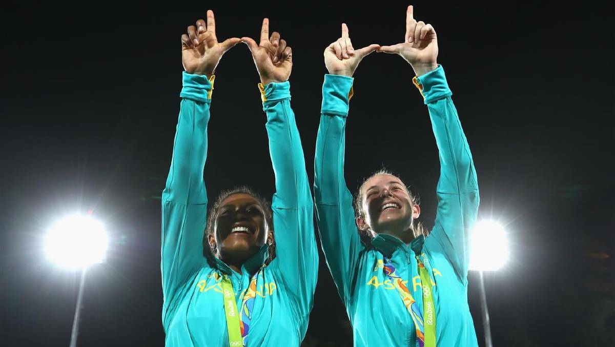 Ellia Green (L) of Australia and her team mate Chloe Dalton pose with her Gold medal after the medal ceremony for the Women's Rugby Sevens on Day 3 of the Rio 2016 Olympic Games at the Deodoro Stadium on August 8, 2016 in Rio de Janeiro, Brazil. Photo: Alexander Hassenstein/Getty Images