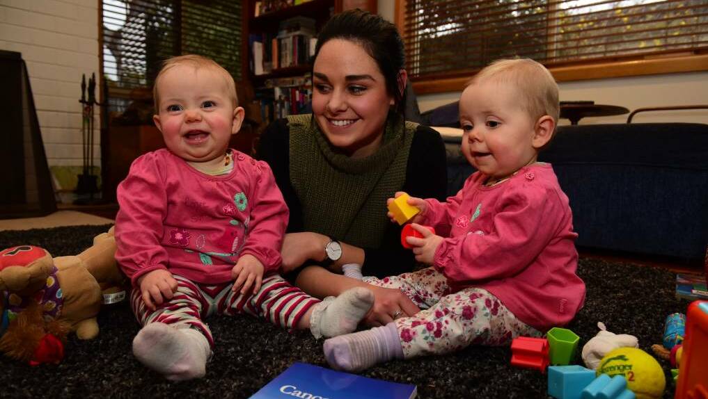 AUTHOR: Launceston's Georgina McCormack and her twin 10-month-old daughters Ruby and Grace. The 25-year-old has written a book detailing her battle with cancer. Photo: Paul Scambler
