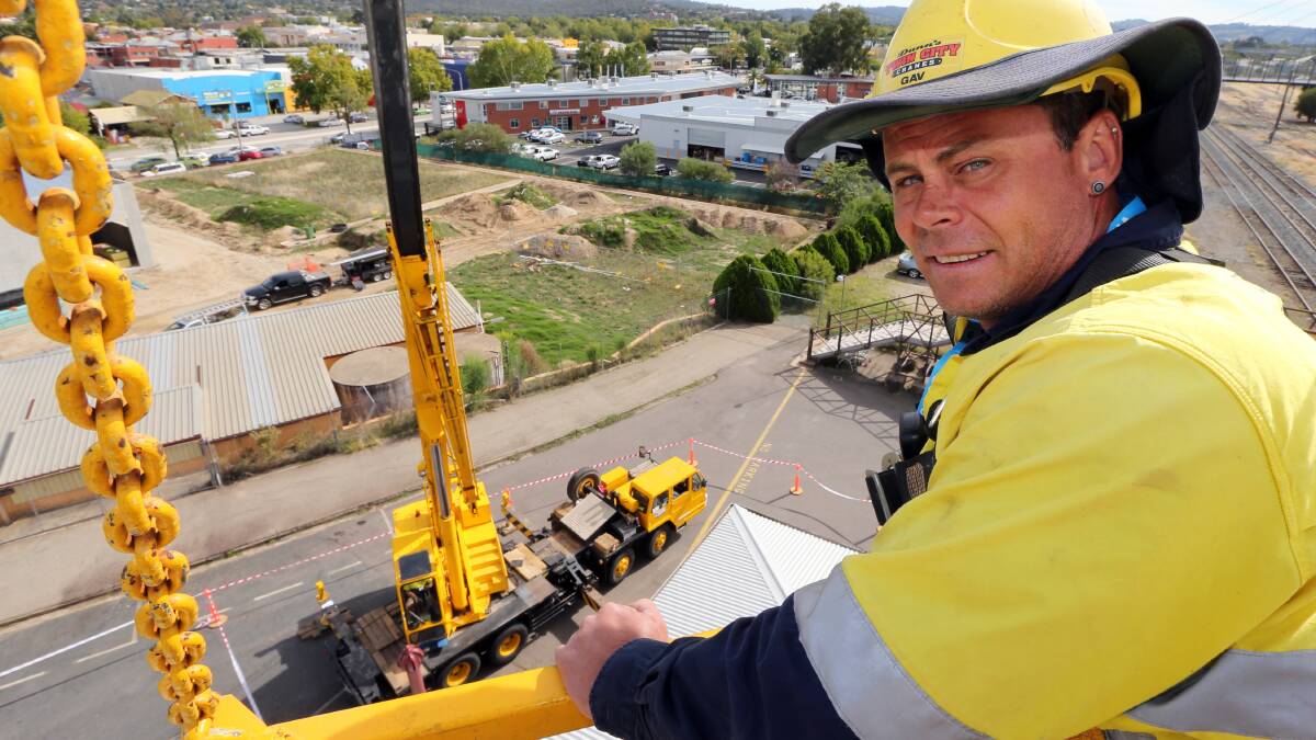 Crane operator Jeff Plum, of Dunn's Cranes, takes the workers up to the chimneys. 