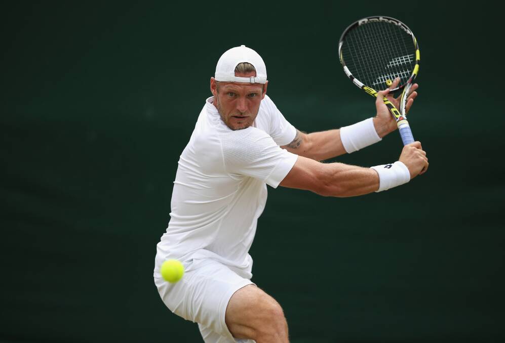 Sam Groth plays a backhand in his match against roommate James Duckworth at Wimbledon on Thursday night. Picture: GETTY IMAGES