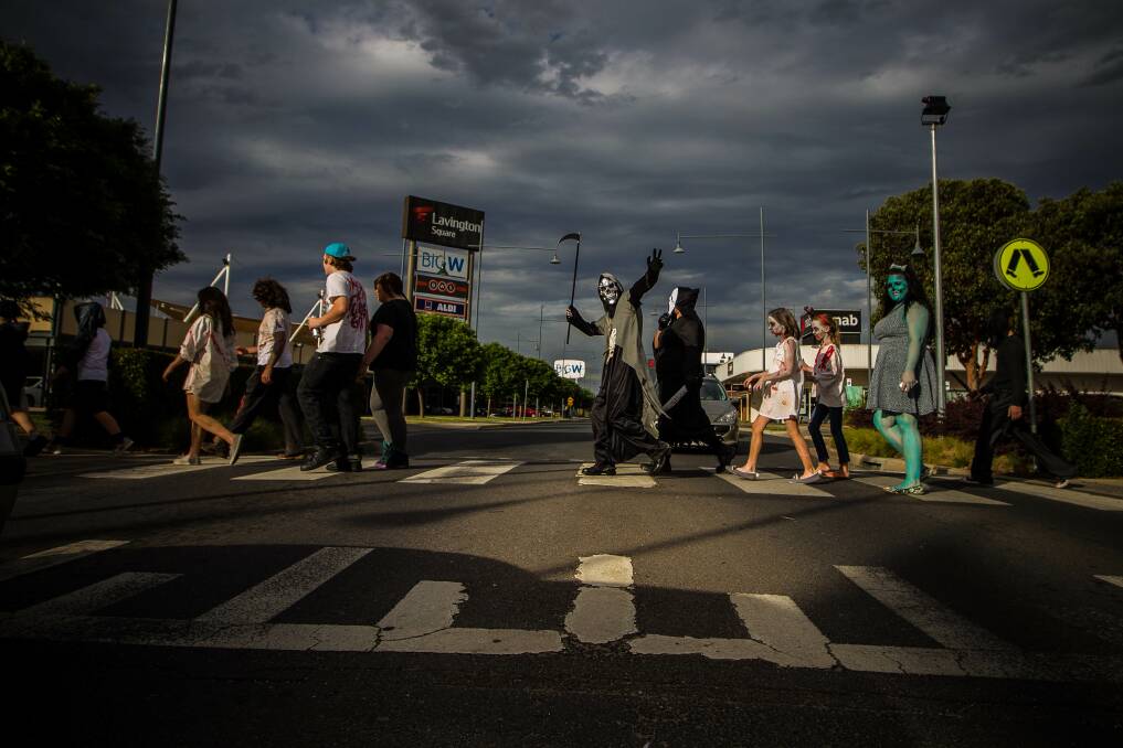 Zombies, witches and various murder victims cross the road in Albury's first Zombie Walk. Picture: DYLAN ROBINSON