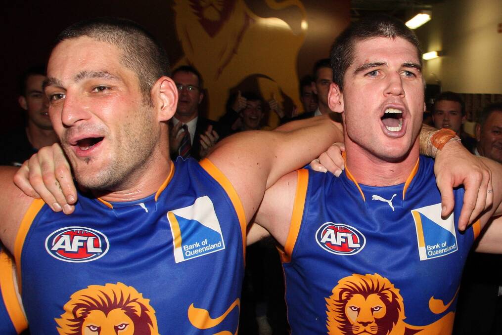 Brendan Fevola and Jonathan Brown belt out the Lions’ song after a 2010 victory over the Bulldogs. Pictures: GETTY IMAGES