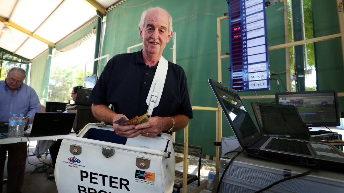 Bookmaker Peter Brown working on his stand at Wangaratta. Picture: MATTHEW SMITHWICK