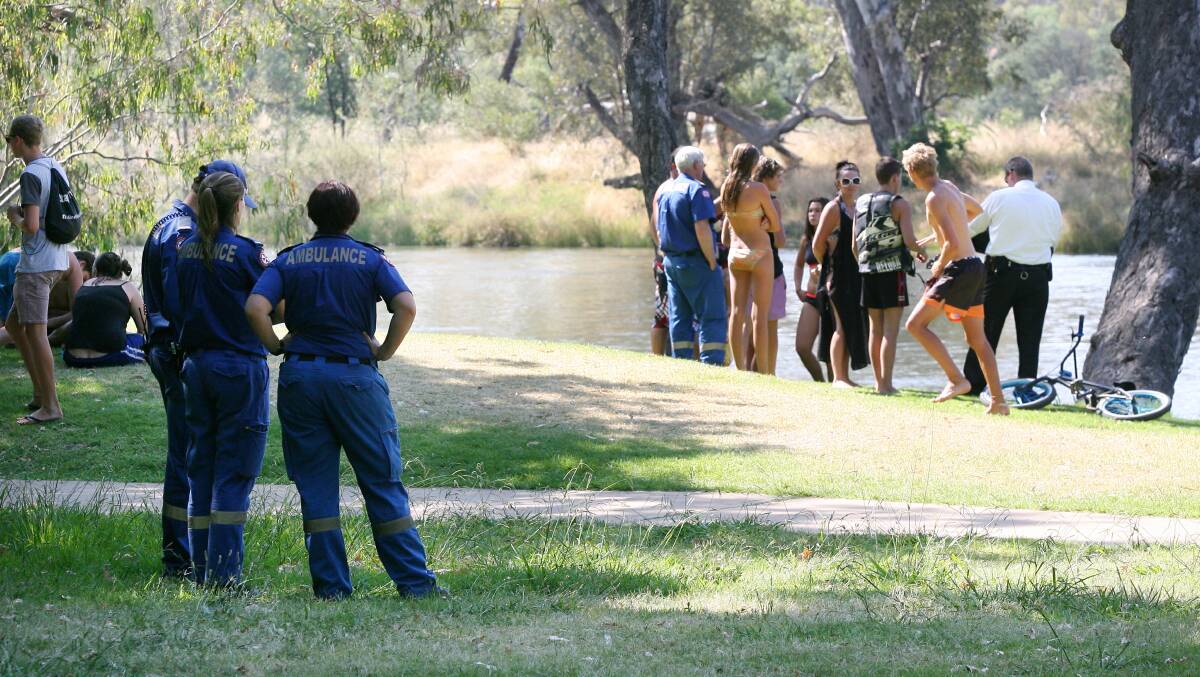 Swimmers watch from the bank as search and rescue workers kicked off a search for Abdul Ehsani's body. Picture: TARA GOONAN