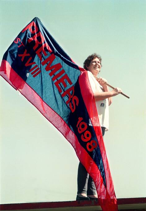 Faye Reeve at the home of her beloved Raiders football ground, waves the flag proudly. Picture: CHRIS McCORMACK