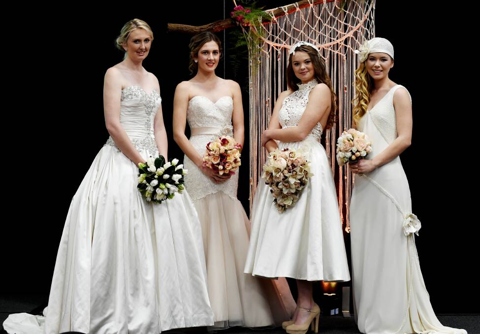 Models Claire Baxter and Kristen Wright wearing gowns from Ferrari Formalwear and Bridal with Tilly Morris and Lily Barker wearing Jillian Franklin Designs at yesterday’s Bridal Fair. Pictures: MARK JESSER
