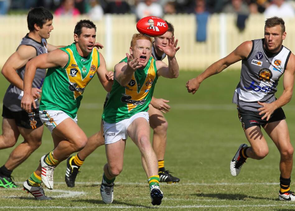 Brian Durbidge lunges at the football during last year's Anzac Day clash. Picture: MATTHEW SMITHWICK