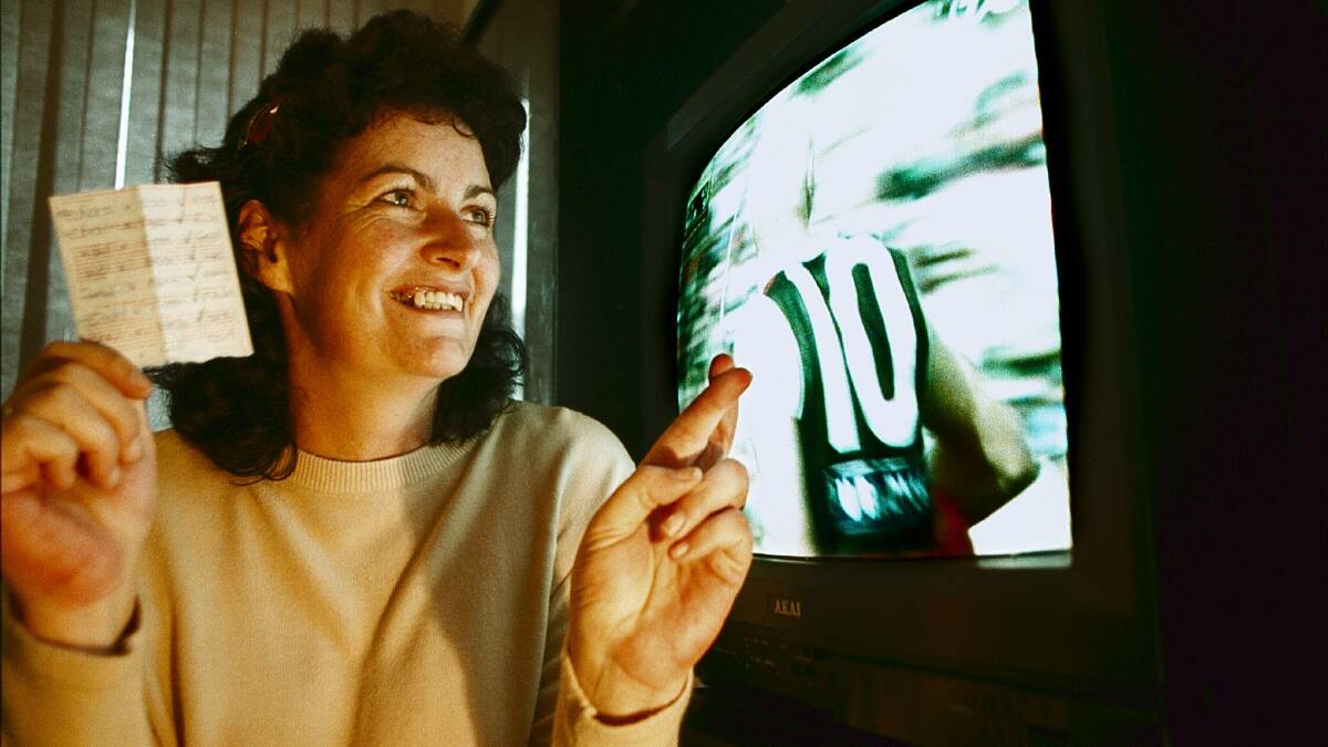 Frances Hughes crosses her fingers in the hope of winning the Border Mail AFL footy tipping competition. (Check out the old TV!) Picture: CHRIS McCORMACK 