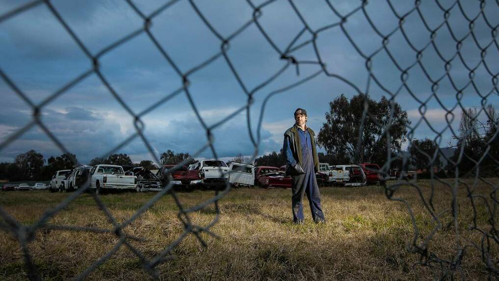 Australian 4x4 Dismantlers has been broken into for the fourth time in six weeks. Owner Will Deuchar inspects the hole in the fence that the thieves entered through. Picture: DYLAN ROBINSON