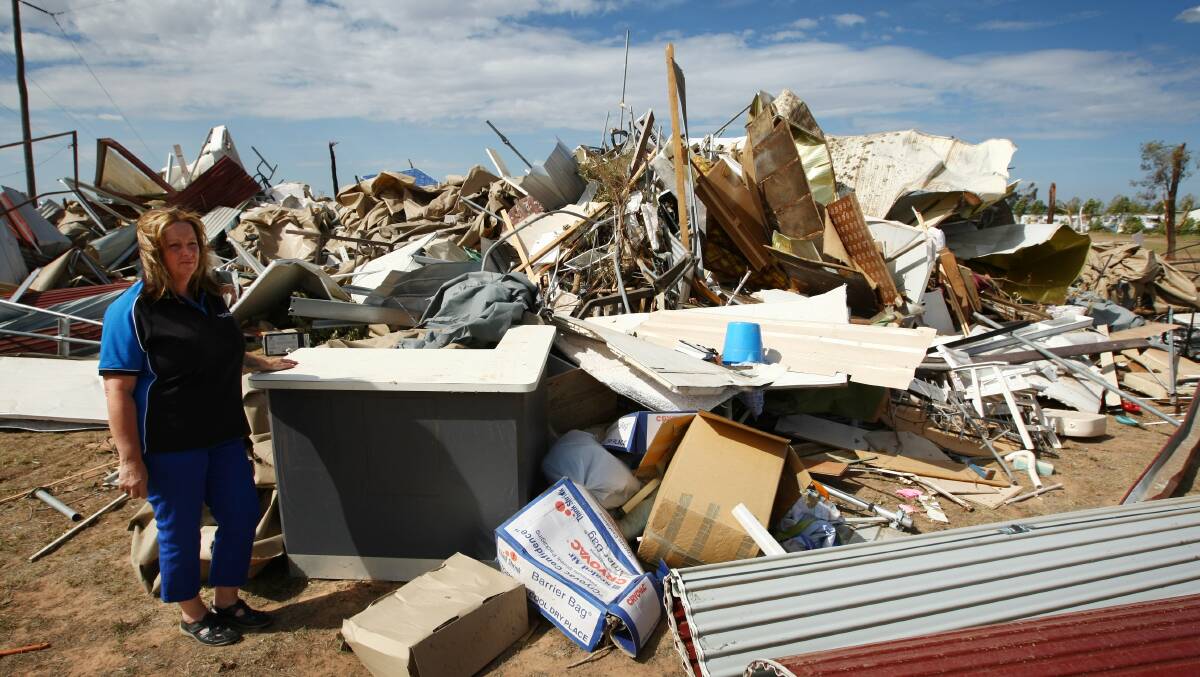 Sun Country Holiday Village manager Jacqui Sonter with a pile of debris. Picture: MATTHEW SMITHWICK