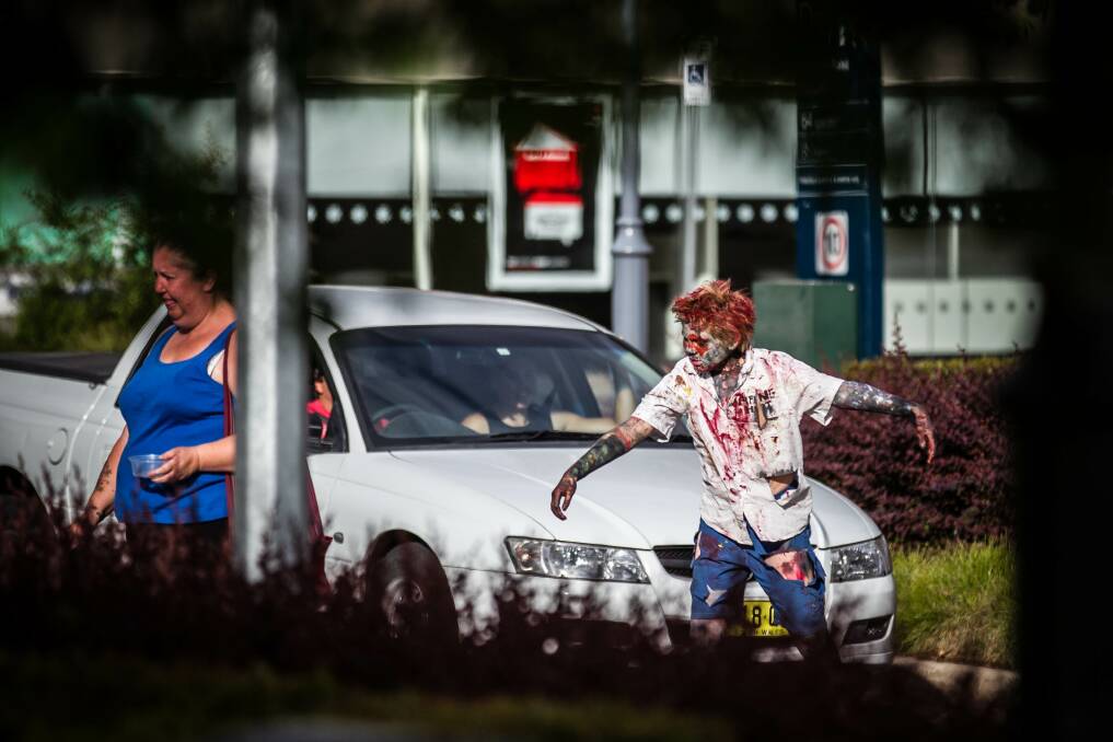 Albury Zombie Walk - A zombie creeps up on an unsuspecting shopper. Picture: DYLAN ROBINSON