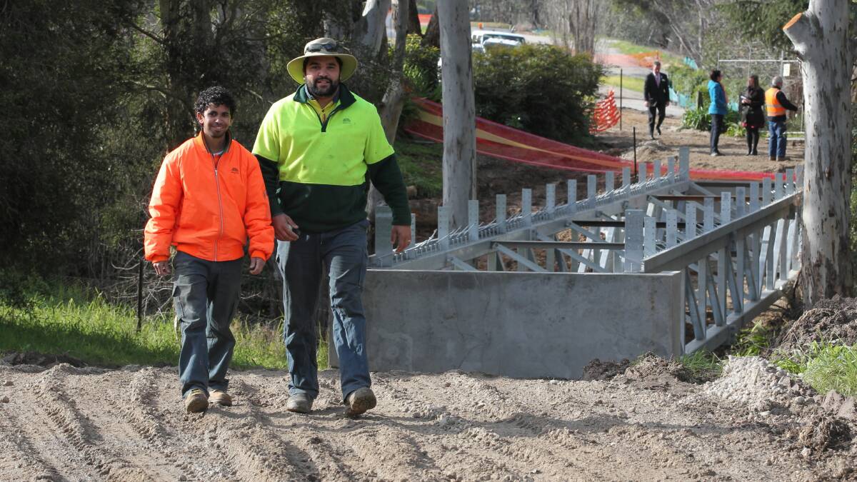Project leading hand Curtis Reid and trainee Jarret Edwards were involved yesterday in installing one on the trail’s two bridges, linking Wonga Wetlands with Horseshoe Lagoon. Picture: DAVID THORPE