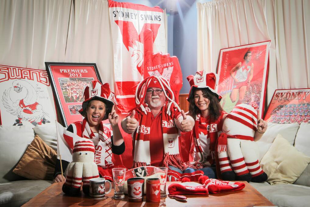 Die hard Sydney Swans supporters Kali Palmer, Greg Williams and daughter Carlee Williams with all the paraphernalia needed to support their team's battle against the Hawks. Picture: DYLAN ROBINSON