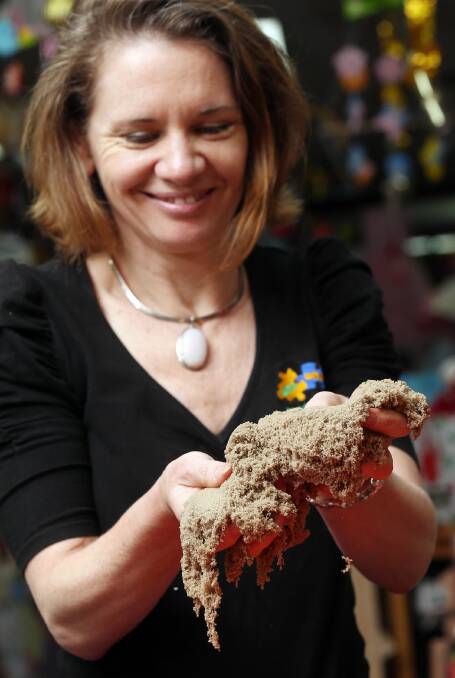 Claire Jorgensen with some kinetic sand, the ‘hottest Christmas ticket in town’.
Picture: JOHN RUSSELL
