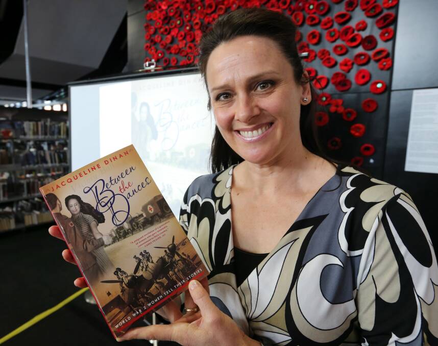 Melbourne author Jacqueline Dinan with her new book about women who lived through World War II. Picture: PETER MERKESTEYN