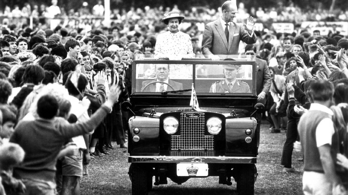 May, 1988 - Prince Philip and Queen Elizabeth II visit Albury-Wodonga. The royals wave to the crowd as they parade through the Albury sportsground.