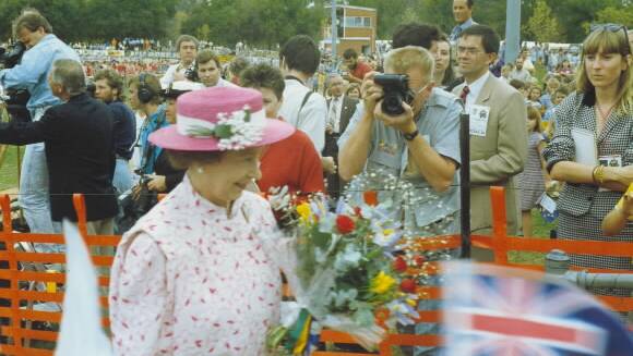 Howard Jones can be seen in the background, reporting on Queen Elizabeth II's royal visit to Albury in 1988.