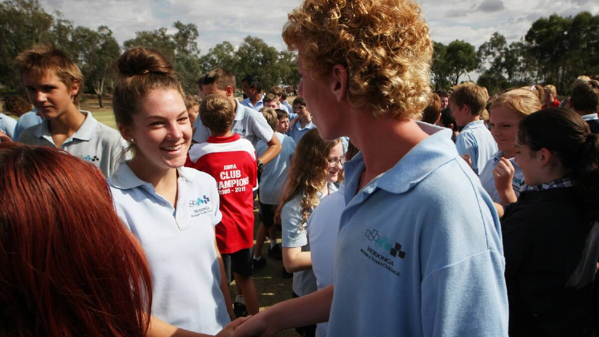Wodonga Middle Year Felltimber School year 9 student Lori Gow, 14, who spoke on the microphone shaking hands with a fellow student. Picture: DYLAN ROBINSON