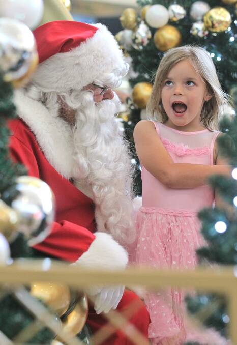 Jacinta Clarke, 6, from Springdale Heights, lets Santa know she’s been good this year and what she’d like for Christmas.
