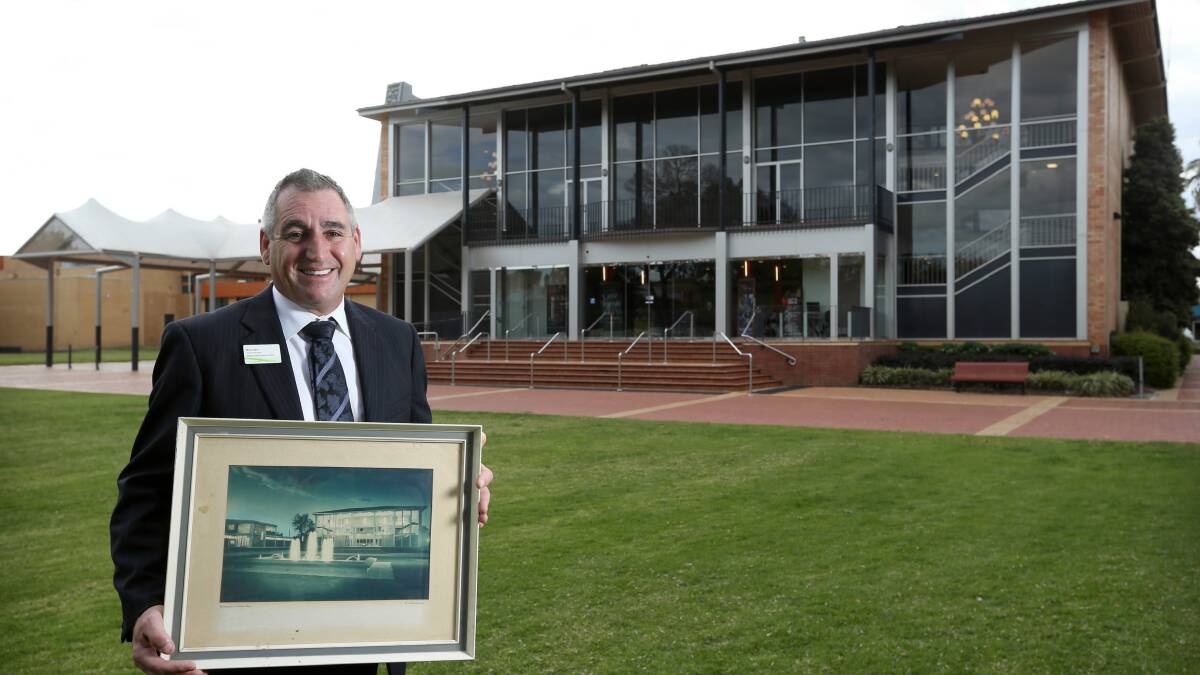 Centre manager Brendan Maher holds a commemorative photo of the then Albury War Memorial Civic Theatre. Picture: MATTHEW SMITHWICK