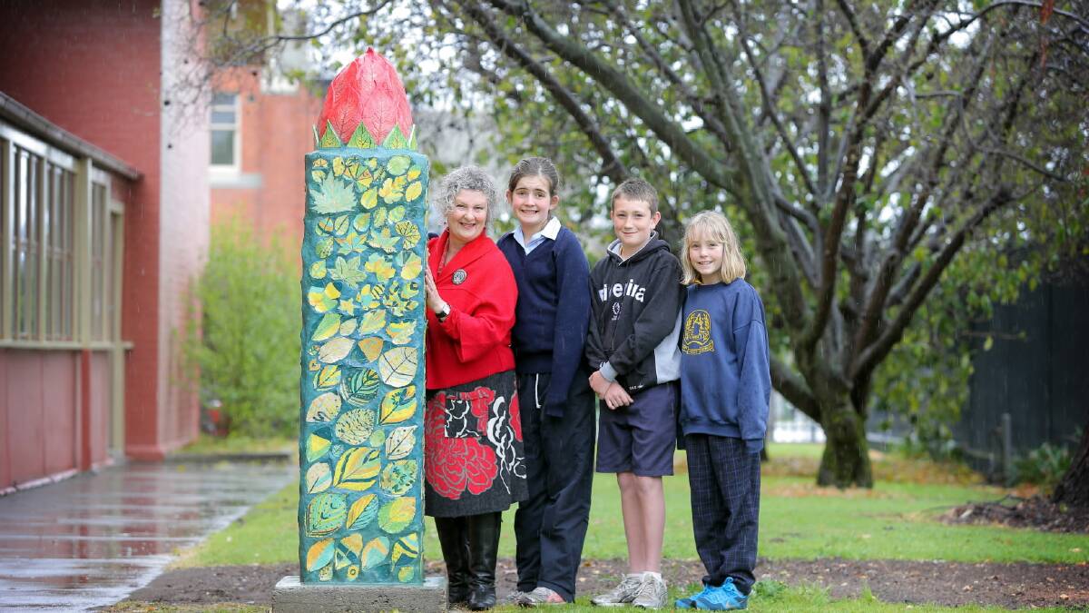 Local artist Linda Fish with Albury Public School year 5 students Annabelle Henderson, 11, Charlie Byrne, 10, and Claudia Murphy, 11. The ceramic sculpture they made is called 'The Budding Young'. Picture: TARA GOONAN