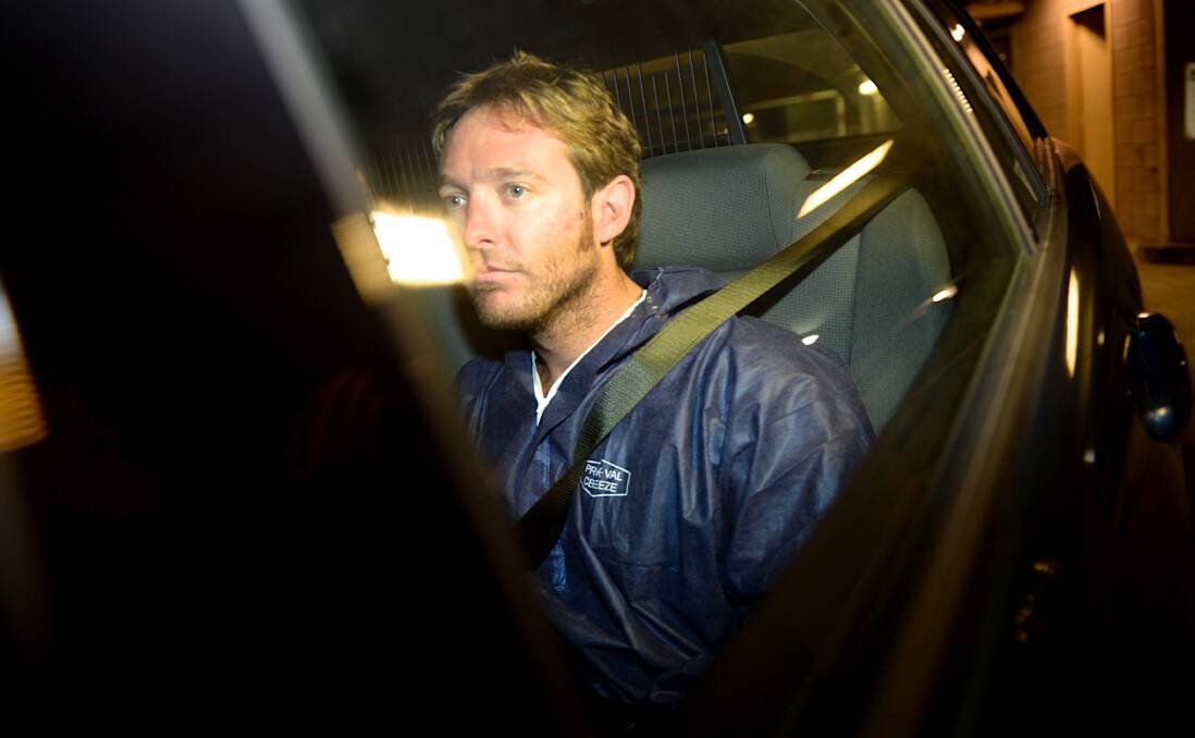 Ian Thomas being taken away from the St Kilda Road Police station, in Melbourne, after being taken into custody in April last year. Picture: FAIRFAX