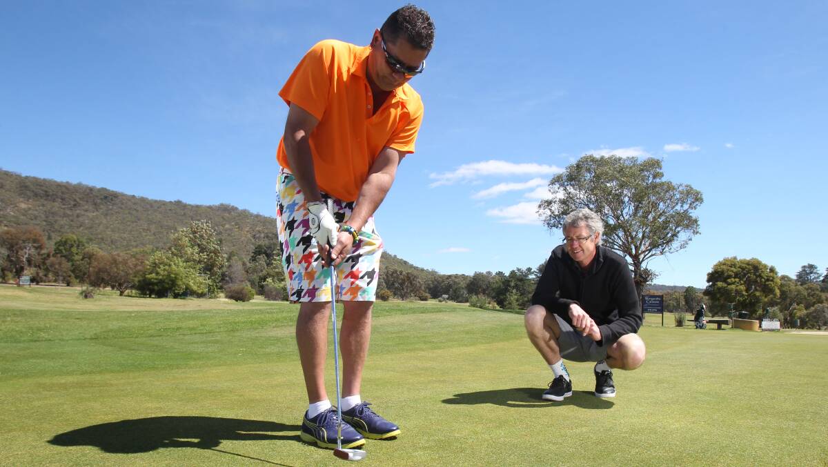 Blind golfer Sean Witting  and coach Ashley Neave have a hit at Wangaratta's Jubilee Golf Club . Picture: MARK JESSER