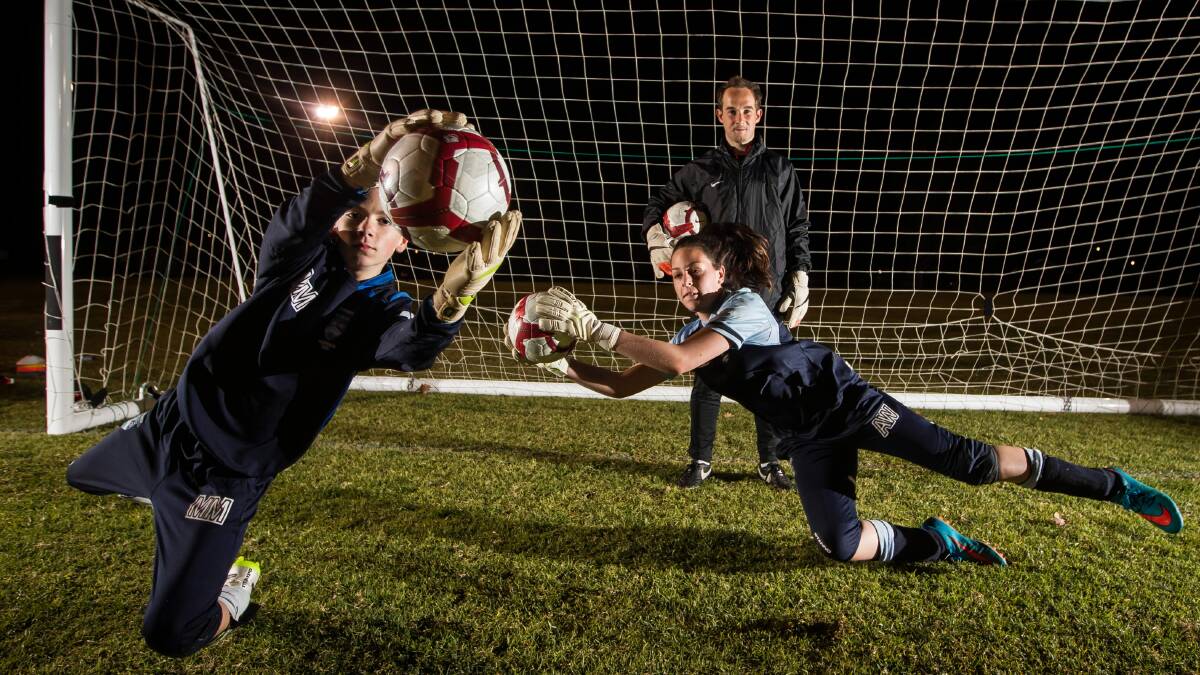 Manchester United goalkeeping coach Jack Robinson passed on some sage advice last night to Mitchyl McCrory, 12, and Ashley Watt, 13, about making their mark. Picture: DYLAN ROBINSON