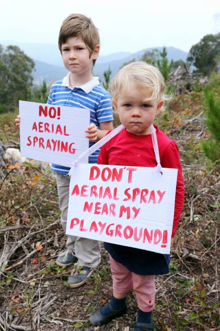 Wylde Wisley, 4, and Eliza Walker, 2, carry signs of protest. Picture: JOHN RUSSELL