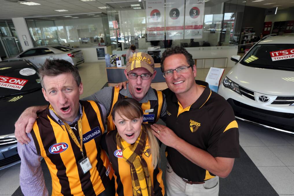 Jacobs Toyota workmates Leigh Robertson, Daniel O’Keeffe, Rebecca Spiers and Clint Dickins donned the brown and yellow in the lead up to today’s grand final. Picture: PETER MERKESTEYN
