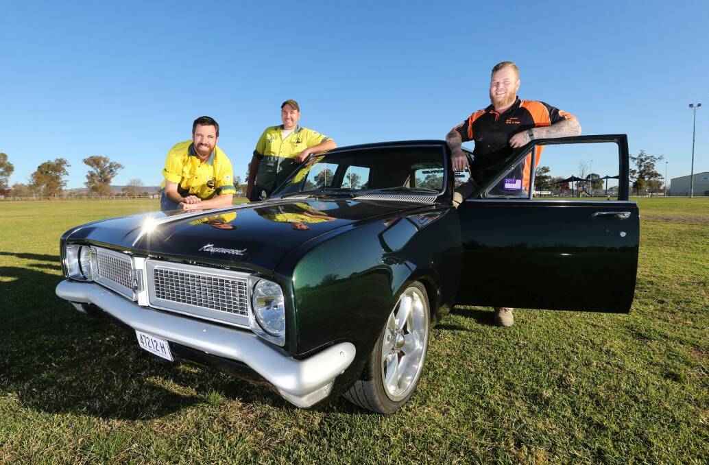 Walla Car Show Swap Meet organisers Daniel Nadebaum, Dave Graham and Jerome Scholz with his 1970 HG Kingswood Panel wagon. The show ’n’ shine is expected to be a drawcard for the event that has been on hiatus for three years. Picture: JOHN RUSSELL