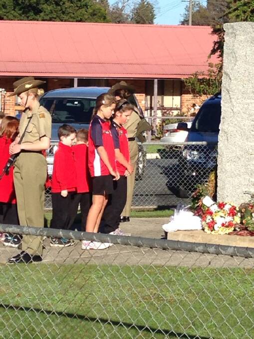 Bethanga Primary School captains Alana McMillan and Amy Wood lay a wreath at the Bethanga ANZAC service. - PETER WOOD (iPHONE)