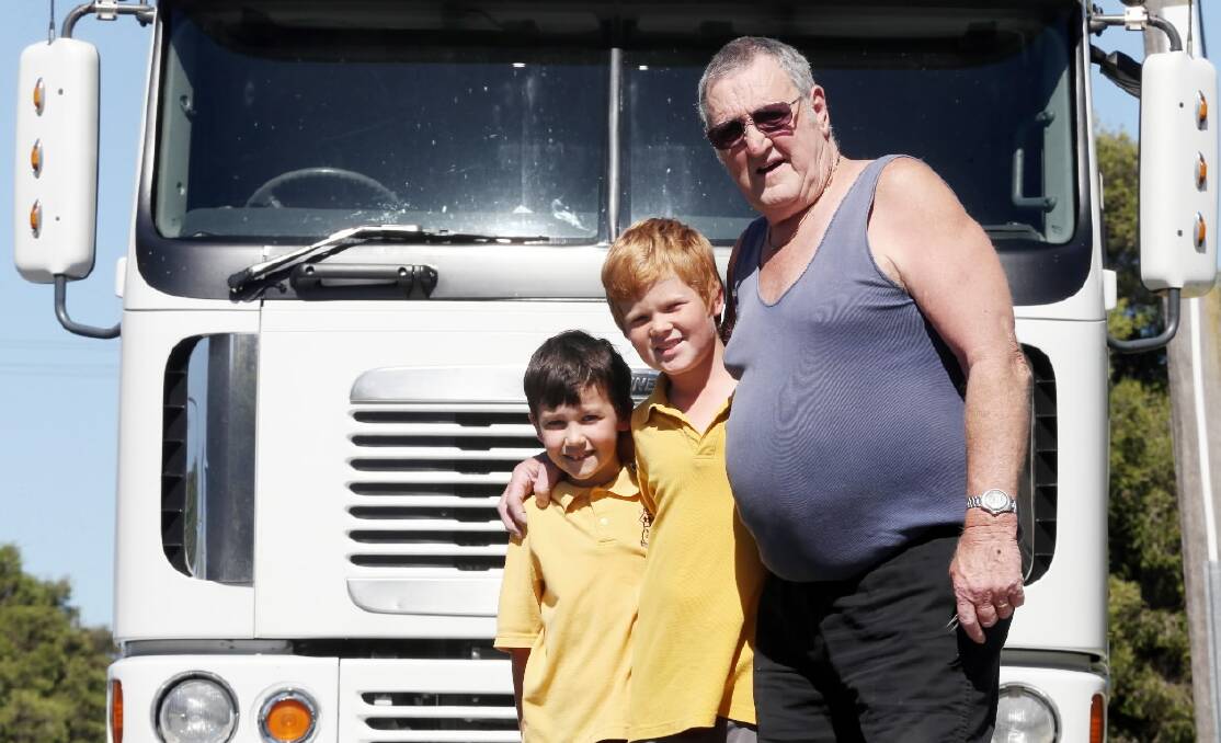 Terry Barker is retiring after a lifetime behind the wheel as a truck driver.  Photographed here his grandsons George (Buster) Harmer, 8, and Samuel (Oscar) Drewe, 12. Picture: JOHN RUSSELL