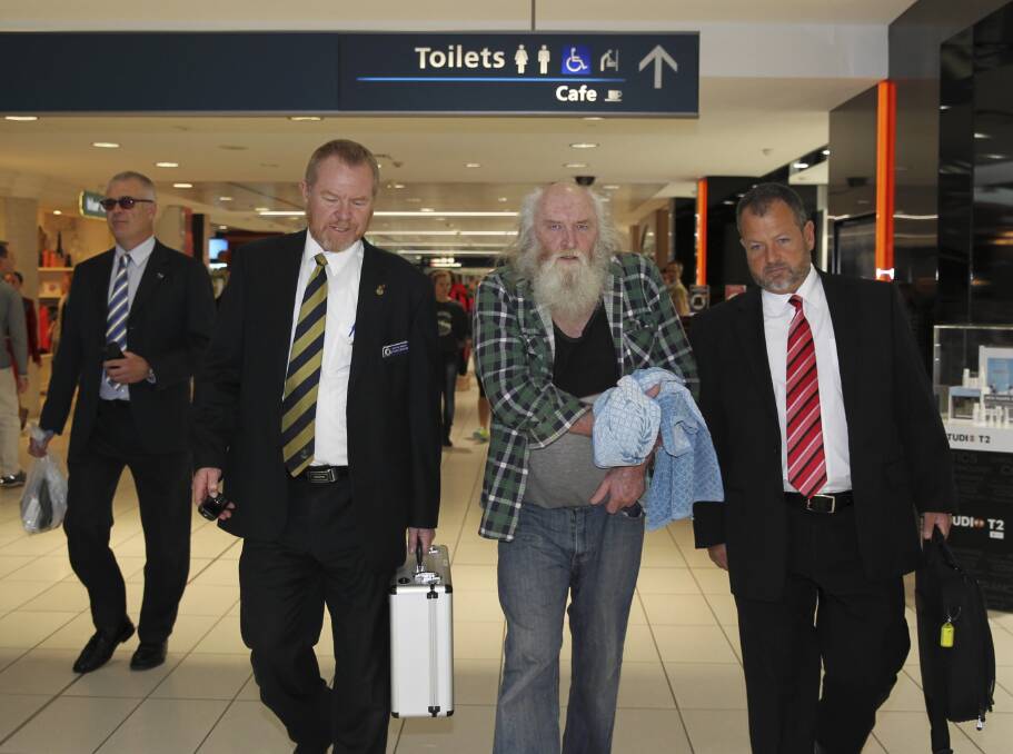 Colin Newey is escorted by Sydney police upon his extradition to NSW yesterday. Picture: FAIRFAX