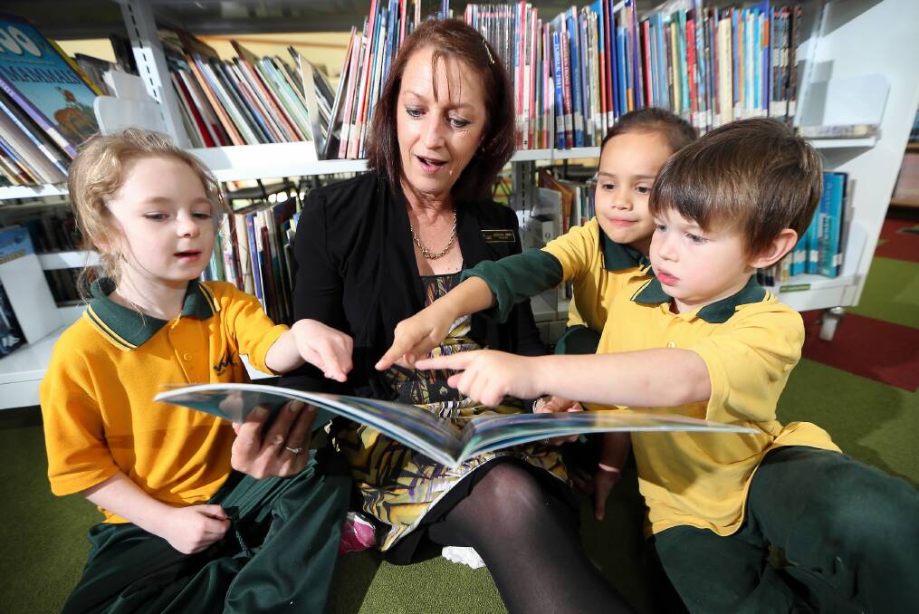Wodonga West Primary School principal Jocelyn Owen, reading with Emily Burt-Drennan, 6, Mia Vanderwerf, 6, and Nicholas Savy, 5, says the Linking Learning project will build on present programs. Picture: JOHN RUSSELL