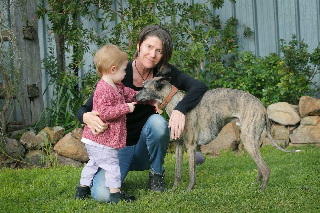 Jessica Browne, 2, and her mum Tonia Oswald-Sealy, with their dog Kozi. Tonia has been diagnosed with motor neurone disease and is sharing her journey. Picture: TARA GOONAN