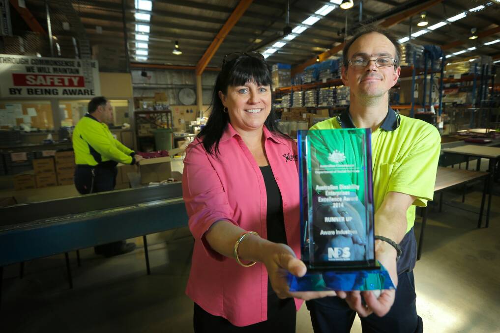 Aware Industries were awarded runners up in the Australian Disability Enterprises Excellence Award. CEO Sharon Muggivan and process worker Adam Hanns with the award on the factory floor. Picture: TARA GOONAN