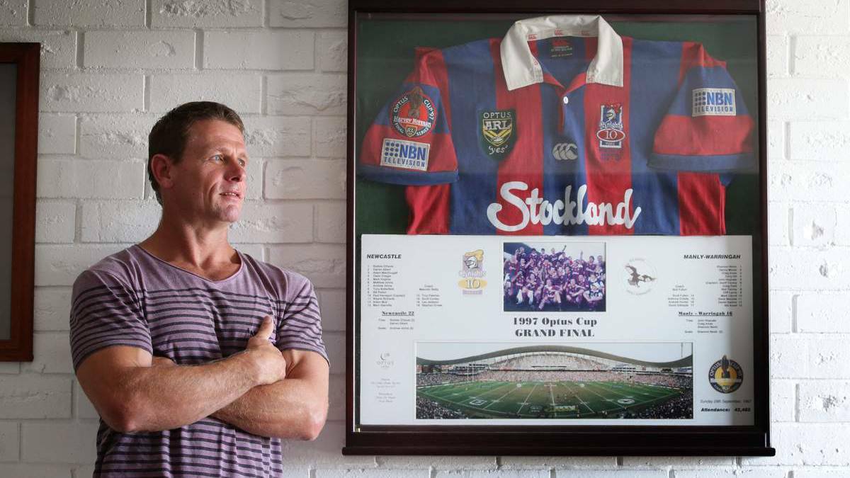 PRIZED POSSESSION: Bill Peden at home yesterday with the Knights jersey he wore in the 1997 grand final. Picture: Dean Osland – The Newcastle Herald