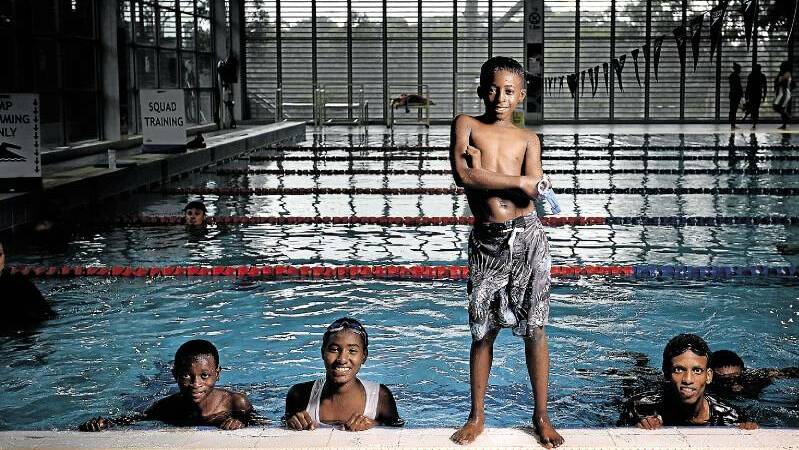 DIVING IN: Piaget Abayo, 12, learns to swim with other refugees from Africa at The Forum, Newcastle University. Picture: Marina Neil