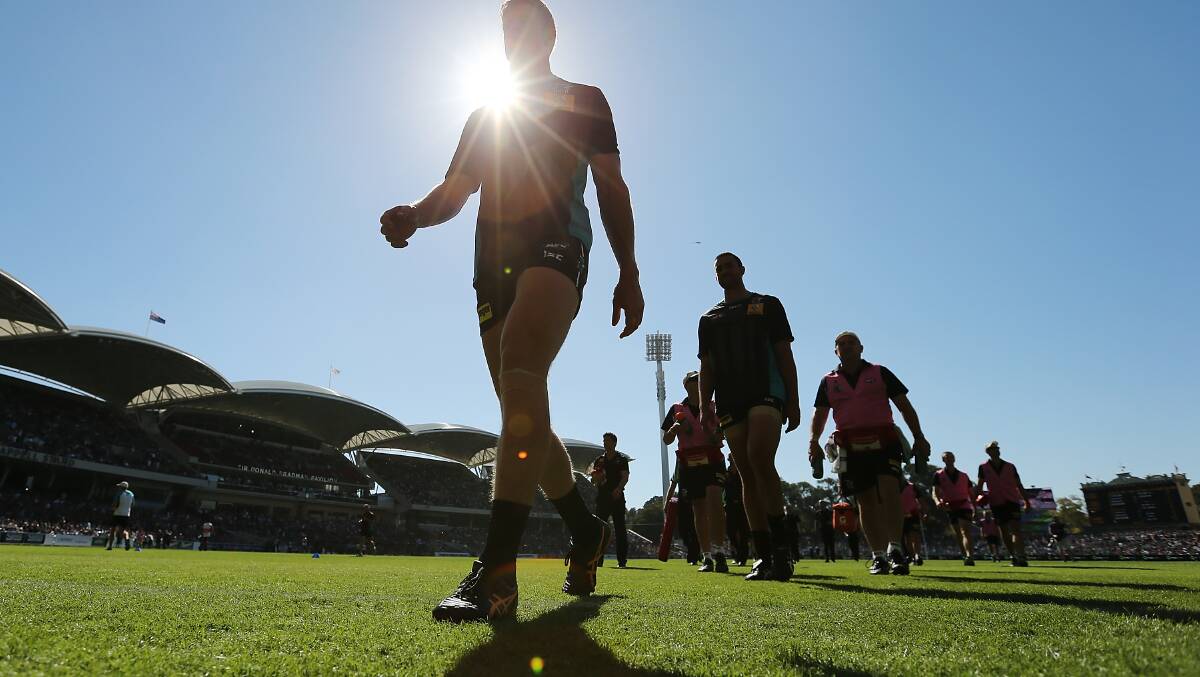 Power players come from the field after their warm-up ready for round two of the AFL season. Photos: Getty